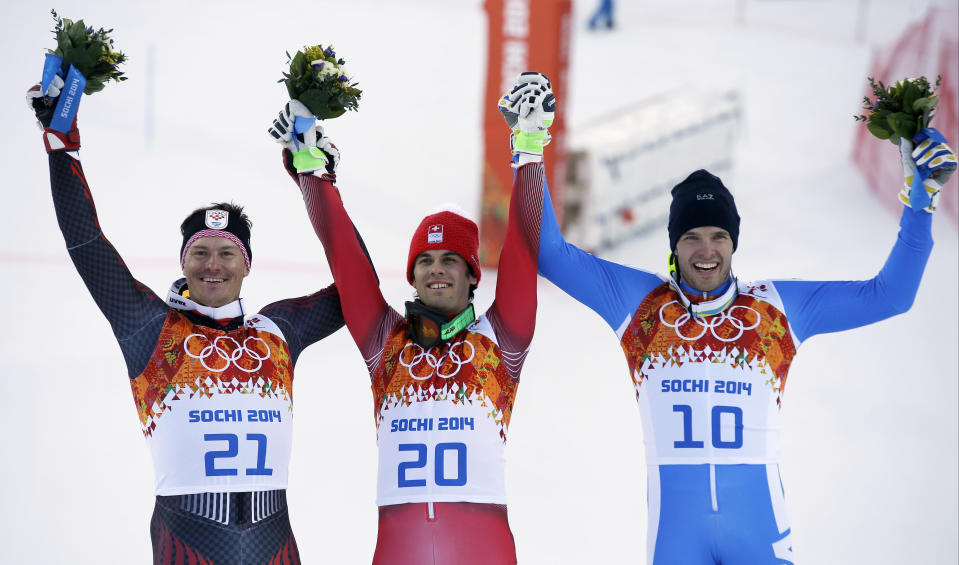 Men's supercombined medalists from left, Croatia's Ivica Kostelic (silver), Switzerland's Sandro Viletta (gold) and Italy's Christof Innerhofer (bronze) pose for photographers on the podium during a flower ceremony at the Alpine ski venue at the Sochi 2014 Winter Olympics, Friday, Feb. 14, 2014, in Krasnaya Polyana, Russia.(AP Photo/Christophe Ena)