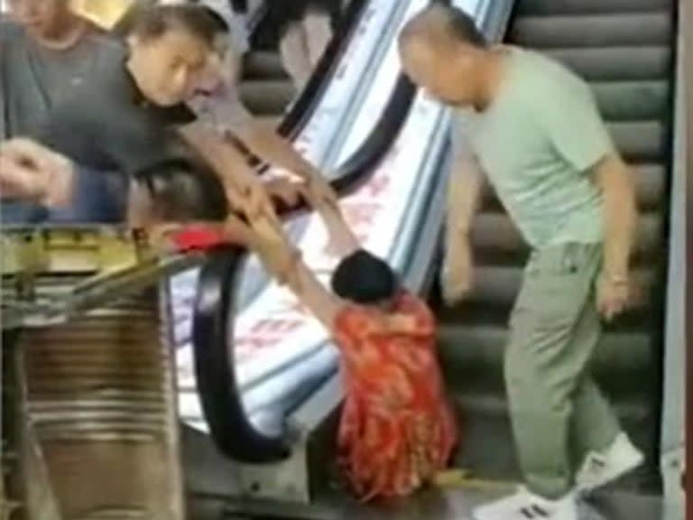 A woman has reportedly had her leg crushed by a moving escalator at a shopping centre in China.Video footage published by a local news agency showed the woman, who is said to be in her sixties, trapped from the waist down after part of the staircase collapsed beneath her.A family member said she had fallen into the machinery when the metal steps gave way without warning at the centre in the northeast city of Harbin.When firefighters freed the woman, who has not been identified, they were forced to sever her left leg below the knee, local media reported.The relative said a number of steps had given way causing the victim to tumble into cogs beneath.They added that she had tried to climb out but had nothing to step on during the ordeal, which local media reported happened on Saturday. The Independent was unable to verify the footage.Other eyewitnesses said the woman had attempted to use the steps while workmen were doing repairs.An unnamed shopkeeper said: “There were barriers all around it. She removed the barriers and stepped onto the escalator. The escalator had just been repaired and was still being tested.”Another woman added: "The step broke as soon as she stepped on it."The victim herself is now said to be in a stable condition after undergoing emergency surgery.The cause of the accident is being investigated by authorities.