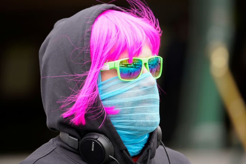 A person wears a scarf as a protective face mask in Melbourne, the first city in Australia to enforce mask-wearing to curb a resurgence of COVID-19