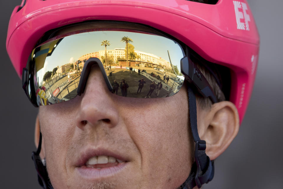 An empty presentation venue is reflected in the glasses of EF Pro Cycling's Sep Van Marcke, of Belgium, before the start of the seventh stage of the Paris Nice cycling race in Nice, southern France. The eighth and final stage of the event was cancelled and spectators are prevented from attending the race due to measures in place to prevent the spread of the Covid-19 virus. For most people, the new coronavirus causes only mild or moderate symptoms. For some it can cause more severe illness. Stage seven runs just over 166 kilometers starting in Nice and finishing in Valdeblore La Colmiane, France, Saturday, March 14, 2020. (AP Photo/Daniel Cole)