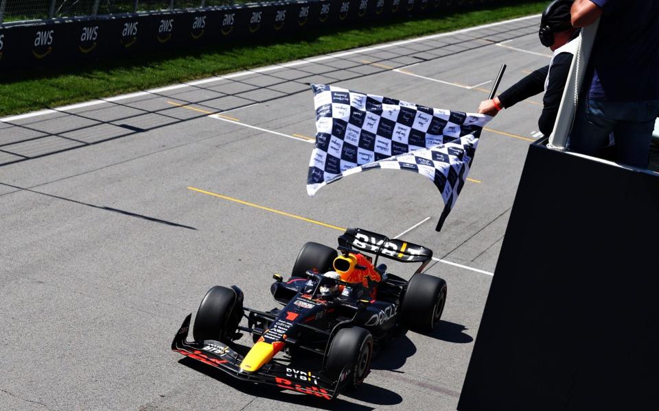 MONTREAL, QUEBEC - JUNE 19: Race winner Max Verstappen of the Netherlands driving the (1) Oracle Red Bull Racing RB18 takes the chequered flag during the F1 Grand Prix of Canada at Circuit Gilles Villeneuve on June 19, 2022 in Montreal, Quebec. - Clive Rose/Getty Images North America