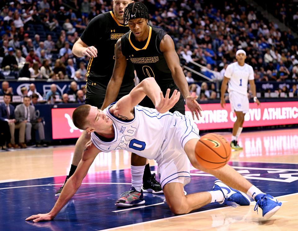 Brigham Young Cougars forward Noah Waterman (0) flips the ball away as Southeastern Louisiana Lions guard Kam Burton (0) defends as BYU and SE Louisiana play at the Marriott Center in Provo on Wednesday, Nov. 15, 2023. BYU won 105-48. | Scott G Winterton, Deseret News