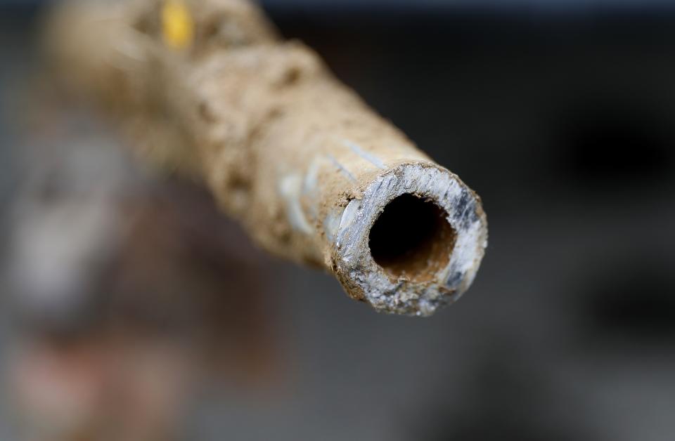 FILE - A lead pipe is shown after being replaced by a copper water supply line to a home in Flint, Mich., July 20, 2018. The Environmental Protection Agency will soon strengthen lead in drinking water regulations. (AP Photo/Paul Sancya, File)