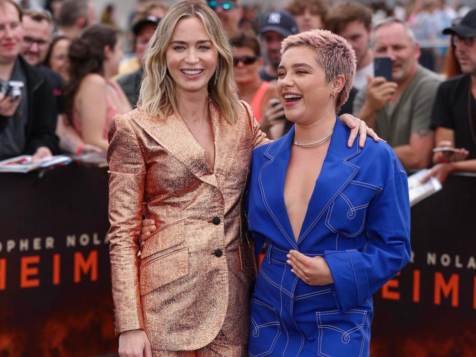 Emily Blunt and Florence Pugh smile together during a photocall after Blunt nearly experienced a wardrobe malfunction.