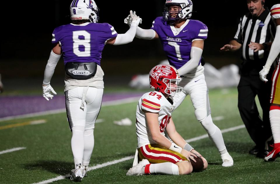 Thomasville punter Andrew Bennett shows his disappointment after being tackled by Calvary's Brody Dawson and Cutter Powell after a bad snap during Friday night's 2nd round matchup.