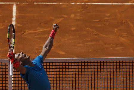 Rafael Nadal of Spain celebrates his victory over Grigor Dimitrov of Bulgaria after their quarterfinal match at the Madrid Open tennis tournament in Madrid, Spain, May 8, 2015. REUTERS/Sergio Perez