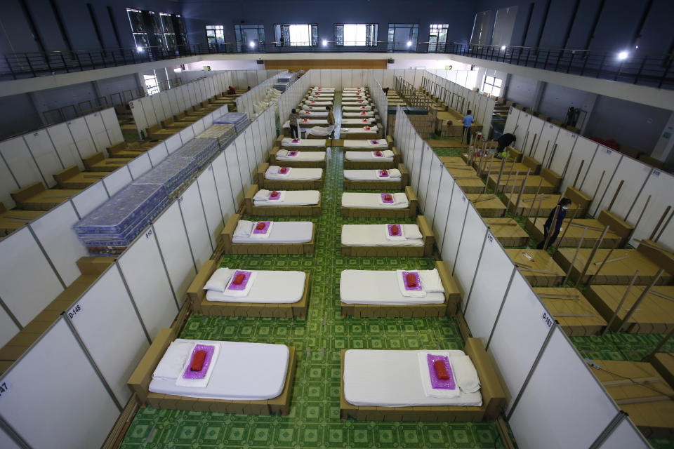 Thai workers prepare a field hospital for COVID-19 patients in Bangkok, Thailand, Monday, April 12, 2021. Thailand's Health Ministry warned Sunday that restrictions may need to be tightened to slow the spread of a fresh coronavirus wave, as the country hit a daily record for new cases. (AP Photo/Somchai Chanjirakitti)