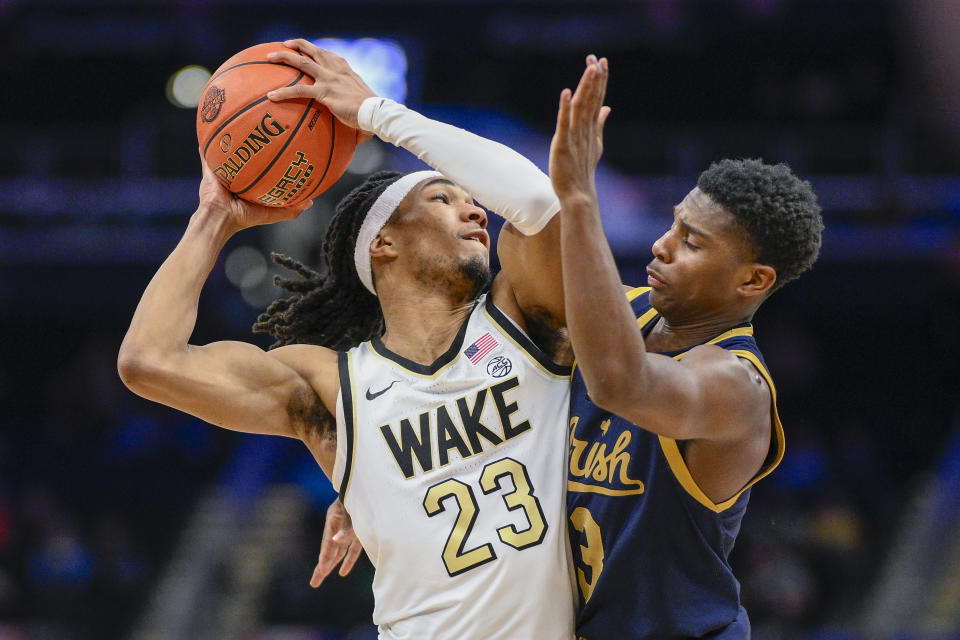 Wake Forest guard Hunter Sallis (23) and Notre Dame guard Markus Burton (3) collide during the second half of the Atlantic Coast Conference second round NCAA college basketball tournament game Wednesday, March 13, 2024, in Washington. (AP Photo/Nick Wass)