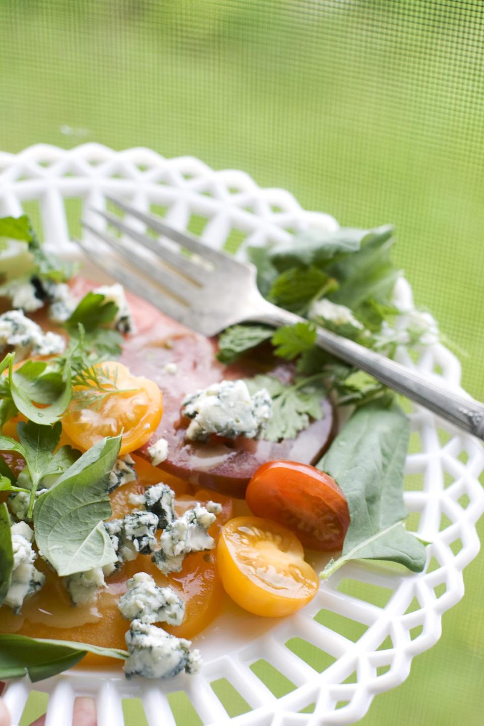 In this image taken on June 10, 2013, an American tomato salad is shown served on a plate in Concord, N.H. (AP Photo/Matthew Mead)