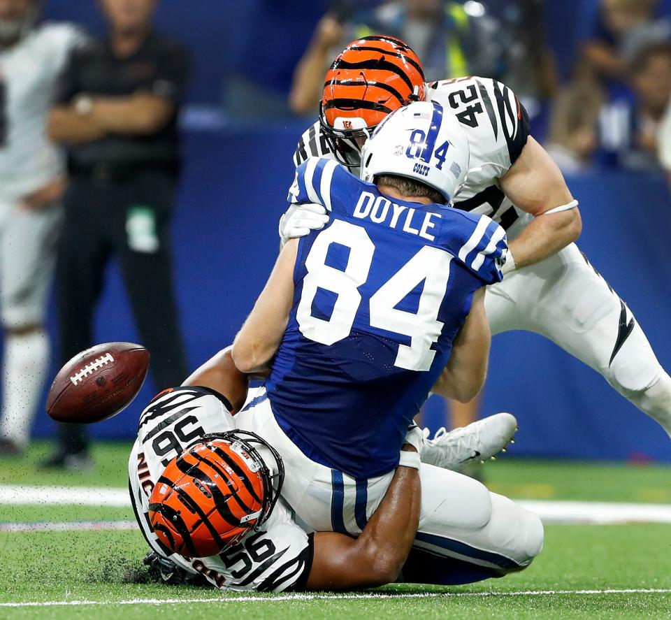 Bengals linebacker Hardy Nickerson (56) and safety Clayton Fejedelem (42) force Colts tight end Jack Doyle (84) to fumble.