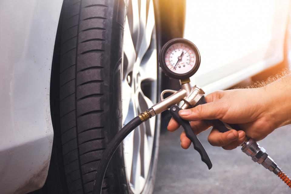 person adding air to a tire