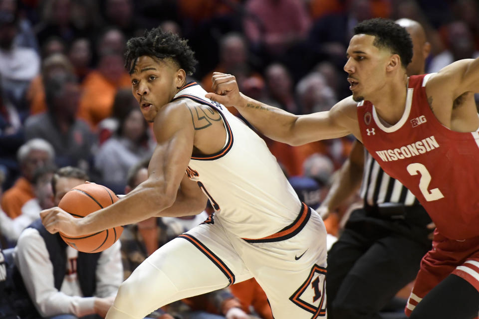 Illinois' Terrence Shannon Jr., left, works the ball inside against Wisconsin's Jordan Davis (2) during the first half of an NCAA college basketball game, Saturday, Jan. 7, 2023, in Champaign, Ill. (AP Photo/Michael Allio)