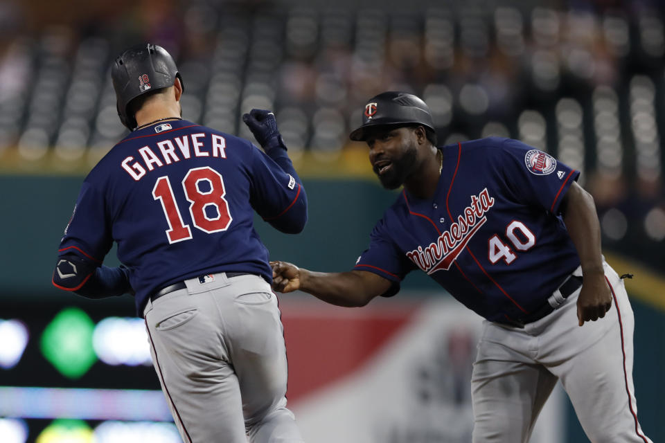 Minnesota Twins' Mitch Garver is greeted by first base coach Tommy Watkins after a solo home run during the ninth inning of a baseball game Saturday, Aug. 31, 2019, in Detroit. Garver's home run was the Twins 268th home run of this season, a MLB record for most home runs by a team in a single season. (AP Photo/Carlos Osorio)