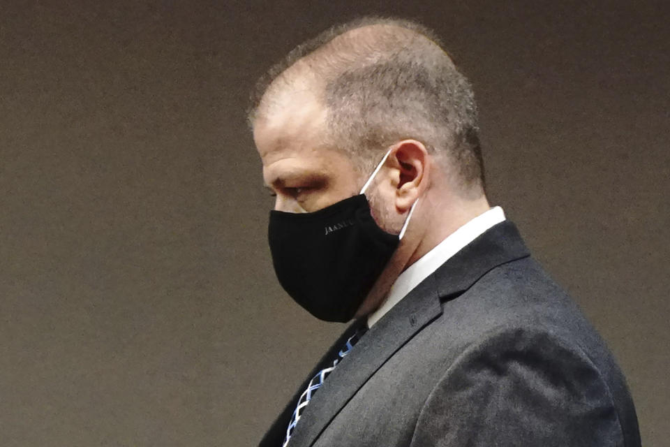 Andrew Polovin, right, a former supervisor with the Illinois Department of Children and Family Services, walks to the podium in the courtroom of Judge Robert Wilbrandt during his arraignment hearing at the McHenry County Courthouse on Thursday, Sep. 17, 2020 in Woodstock, Ill. Polovin, one of two former Illinois child welfare workers who investigated abuse allegations involving 5-year-old Andrew "AJ" Freund whose beaten body was found in a shallow grave last year pleaded not guilty Thursday to child endangerment and reckless conduct charges. (Stacey Wescott/Chicago Tribune via AP, Pool)