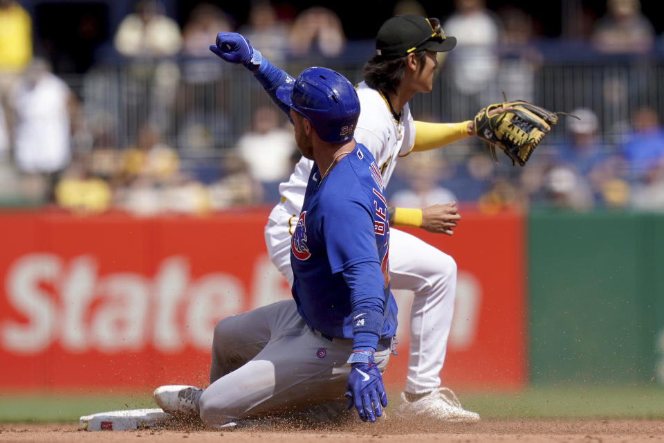 Chicago Cubs' Cody Bellinger slides into second base with an RBI double against Pittsburgh Pirates second baseman Ji Hwan Bae in the fifth inning of a baseball game in Pittsburgh, Sunday, Aug. 27, 2023. (AP Photo/Matt Freed)