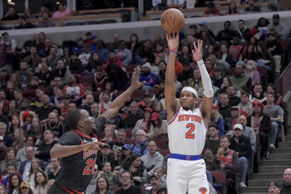 New York Knicks Miles McBride (2) takes a shot from the outside against Chicago Bulls Javonte Green (24) during the second quarter of an NBA basketball game in Chicago, Friday, April 5, 2024. (AP Photo/Mark Black)