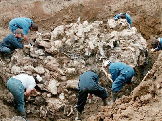 Investigators and forensic experts excavate a mass grave outside the Serb village of Pilica in September 1996. The remains were of Muslim men who had fled Srebrenica after the Bosnian enclave fell to Serbs in July 1995 (Getty)