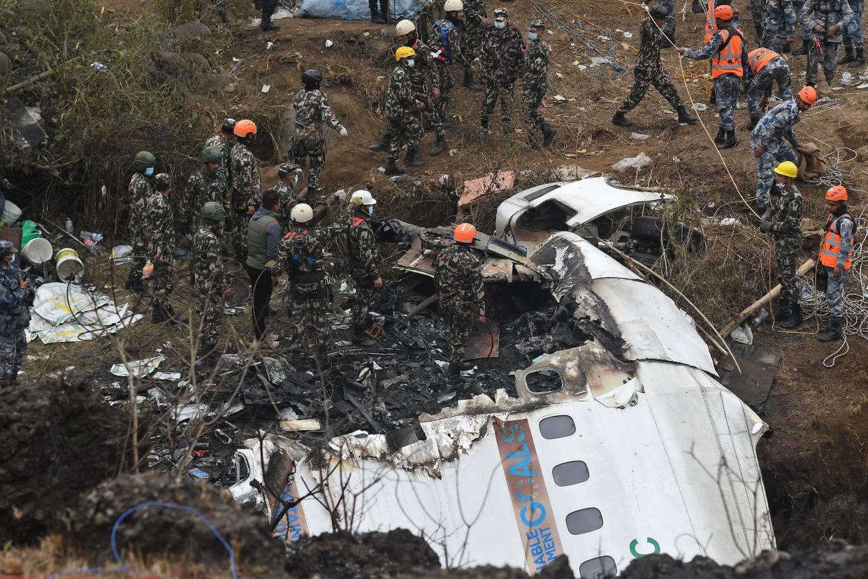 Rescuers inspect the wreckage at the site of a Yeti Airlines plane crash in Pokhara on January 16, 2023.