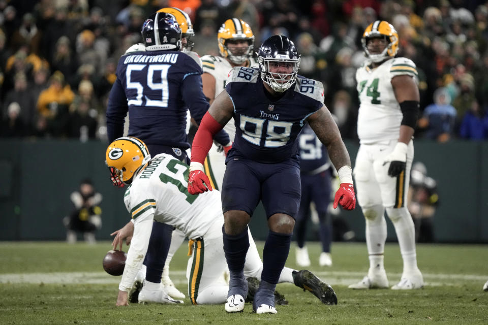 Tennessee Titans defensive tackle Jeffery Simmons (98) celebrates after sacking Green Bay Packers quarterback Aaron Rodgers (12) during the second half of an NFL football game Thursday, Nov. 17, 2022, in Green Bay, Wis. (AP Photo/Morry Gash)