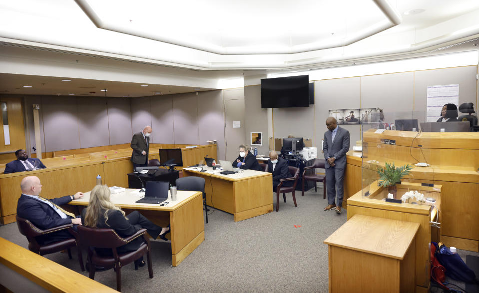 Judge Raquel "Rocky" Jones, right, reads the language back to the defense and prosecution in the 203rd Judicial District Court as motions and language were being sent to the jury after one juror is hanging up the deliberations in the capital murder trial of Billy Chemirmir, seated, right, at the Frank Crowley Courts Building in Dallas, Friday, Nov. 19, 2021. Chemirmir, 48, faces life in prison without parole if convicted of capital murder for smothering Lu Thi Harris, 81, and stealing her jewelry. He is accused of killing at least 18 women in Dallas and Collin counties. (Tom Fox//The Dallas Morning News via AP, Pool)