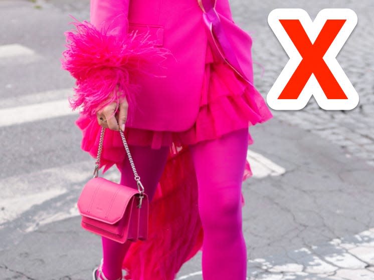 red x next to person wearing all pink outfit walking down street in paris
