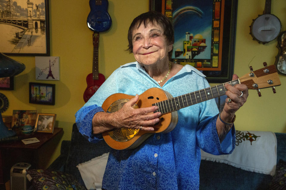 D'yan Forest, 89, who holds the Guinness World Record for Oldest Working Female Comedian, poses in her apartment, Thursday, July 19, 2024, in New York. Forest, a bawdy, ukulele-playing firecracker of a woman who, like Biden, has heard people say "Why don't you retire?" is furious hearing people call for Biden to give up and enthusiastically supports him. "Keep working," she says, "no matter what." (AP Photo/Ted Shaffrey)