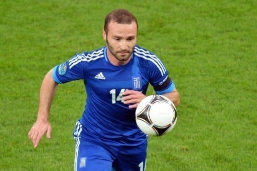 Dimitris Salpingidisis on the ball for Greece during the Euro 2012 match against Germany at the Gdansk Arena. He converted a late penalty to restrict Germany to a 4-2 win