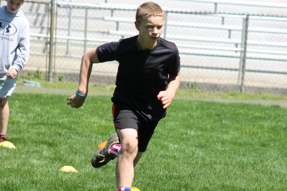 Mason Wattles is all business as he runs a drill during Saturday's football clinic conducted by former New England Patriots running back Jonas Gray at Rochester's Roger Allen Park.