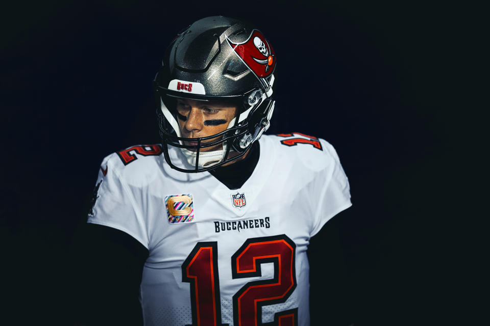 Tom Brady stares to the side in a Buccaneers uniform. 