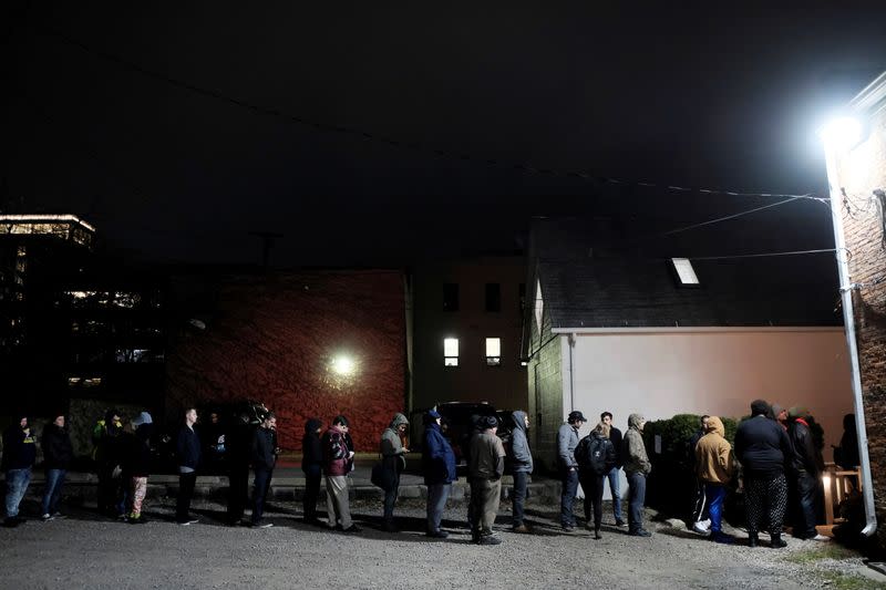 FILE PHOTO: People line up outside of a dispensary after it became legal in the state to sell recreational marijuana in Michigan
