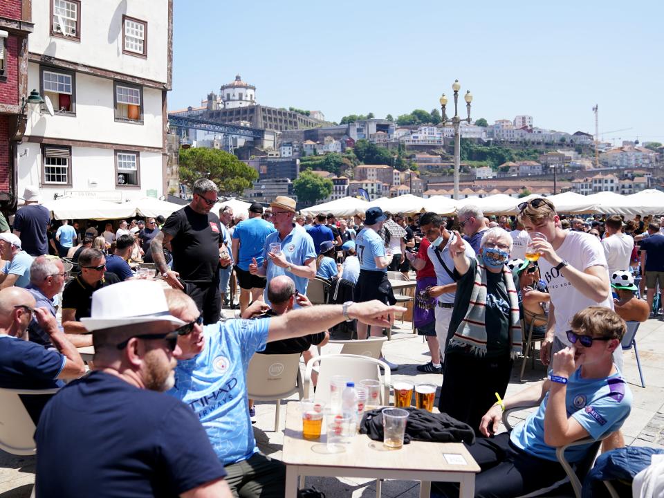 Manchester City fans in Porto city centre (PA)