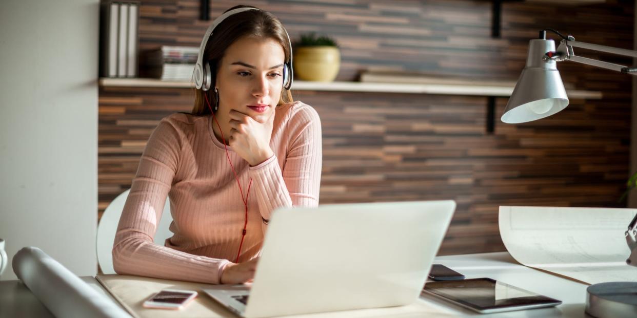 woman using laptop headphones music