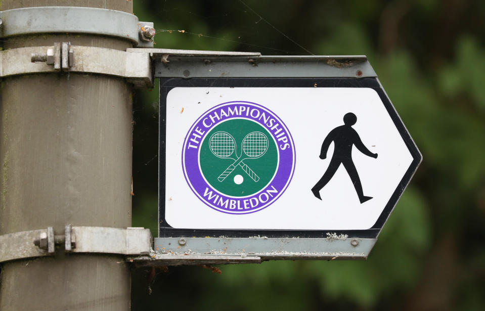 A road sign attached to a lamp post directs pedestrians to the All England Lawn Tennis and Croquet Club, Wimbledon, on what would have been the first day of the famous tennis tournament, which was cancelled this year due to the coronavirus threat. (Photo by Jonathan Brady/PA Images via Getty Images)