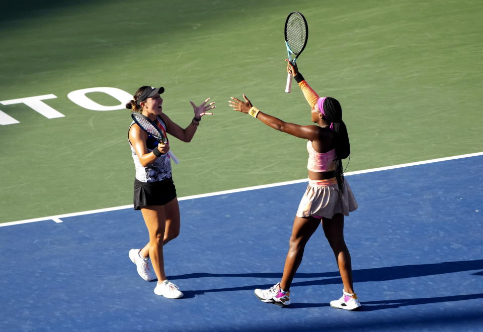 Coco Gauff, right, and Jessica Pegula, both of the United States, react after defeating Nicole Melichar-Martinez, also of the United States and Ellen Perez, of Australia, in the doubles final at the National Bank Open tennis tournament in Toronto, Sunday, Aug. 14, 2022. (Nathan Denette/The Canadian Press via AP)