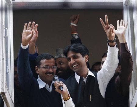 Arvind Kejriwal (L), leader of the newly formed Aam Aadmi (Common Man) Party, waves to his supporters after his election win against Delhi's Chief Minister Sheila Dikshit, at his party office in New Delhi December 8, 2013. REUTERS/Anindito Mukherjee