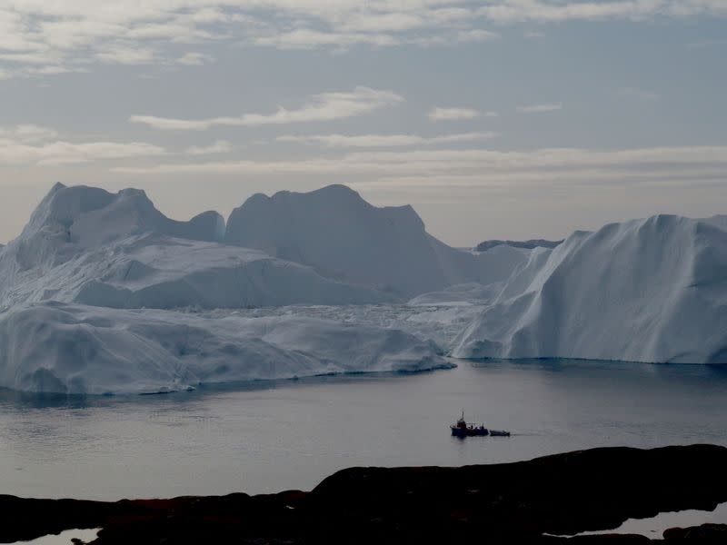 FILE PHOTO: A fishing vessel sails in the ice fjord near Ilulissat