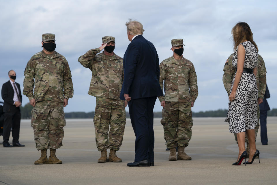 President Donald Trump and first lady Melania Trump arrive at Pope Army Field for an event with troops at Fort Bragg, Thursday, Oct. 29, 2020, in Pope Field, N.C. (AP Photo/Evan Vucci)