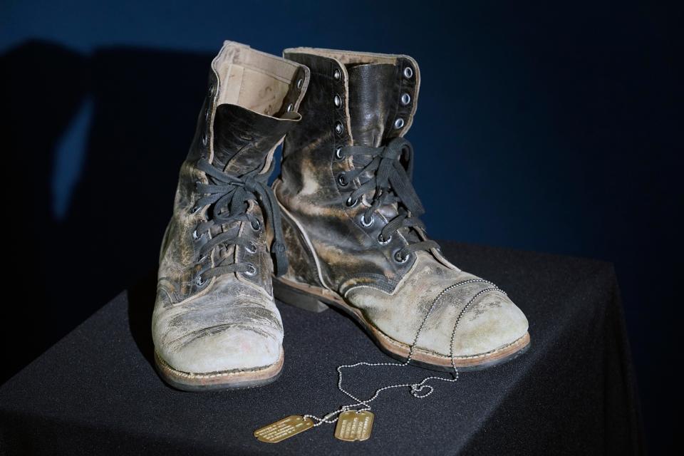 Combat boots and dog tags worn by Alan Alda as he portrayed the wisecracking surgeon Hawkeye on the beloved television series "M-A-S-H" are displayed at Heritage Auctions in Irving, Texas, Wednesday, July 5, 2023. The items are up auction on July 28. (AP Photo/LM Otero)
