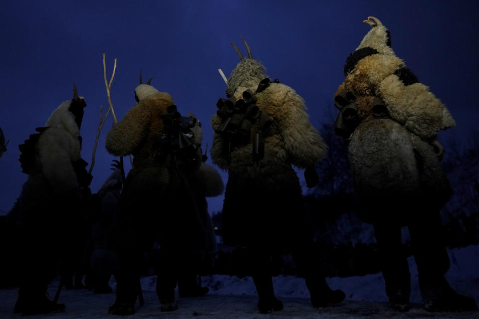 Revelers depicting the devil hold a stick during a traditional St Nicholas procession near the village of Lidecko, Czech Republic, Sunday, Dec. 3, 2023. This pre-Christmas tradition has survived for centuries in a few villages in the eastern part of the country. (AP Photo/Petr David Josek)