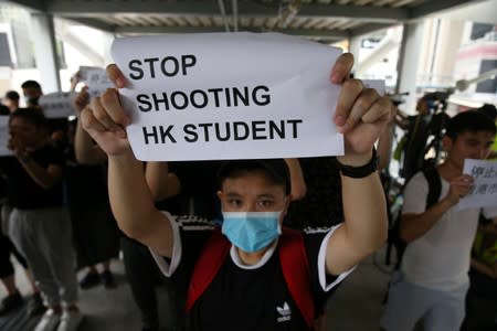 A protester holds a sign following a day of violence in Hong Kong