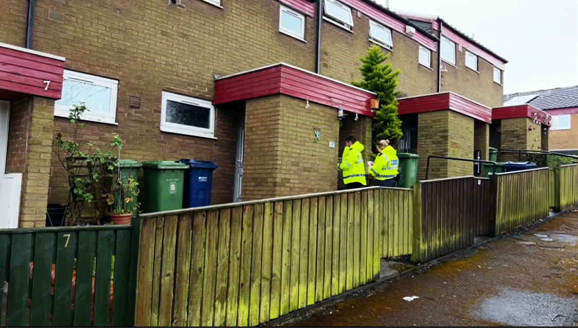 Two police officers going door to door 