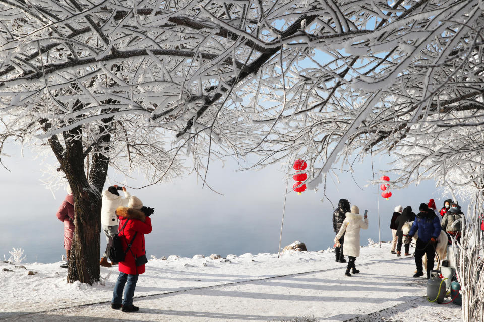 Tourists enjoy rime-covered trees along the Songhua River, January 4, 2023, in Jilin, China. / Credit: Cang Yan/China News Service/VCG via Getty