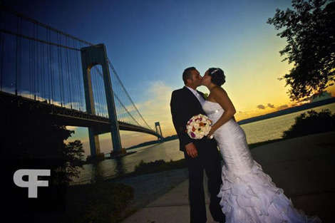 Here, we see the beautiful reception dress as the couple pose for photos beneath the Verrazano Bridge.