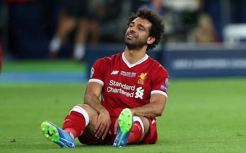 Liverpool's Mohamed Salah looks dejected after sustaining an injury  - Credit: Reuters