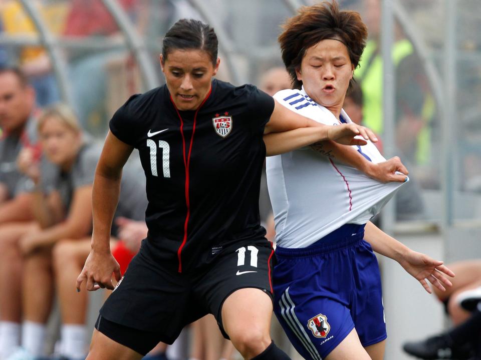 Ali Krieger (left) defends against Japan's Aya Miyama.