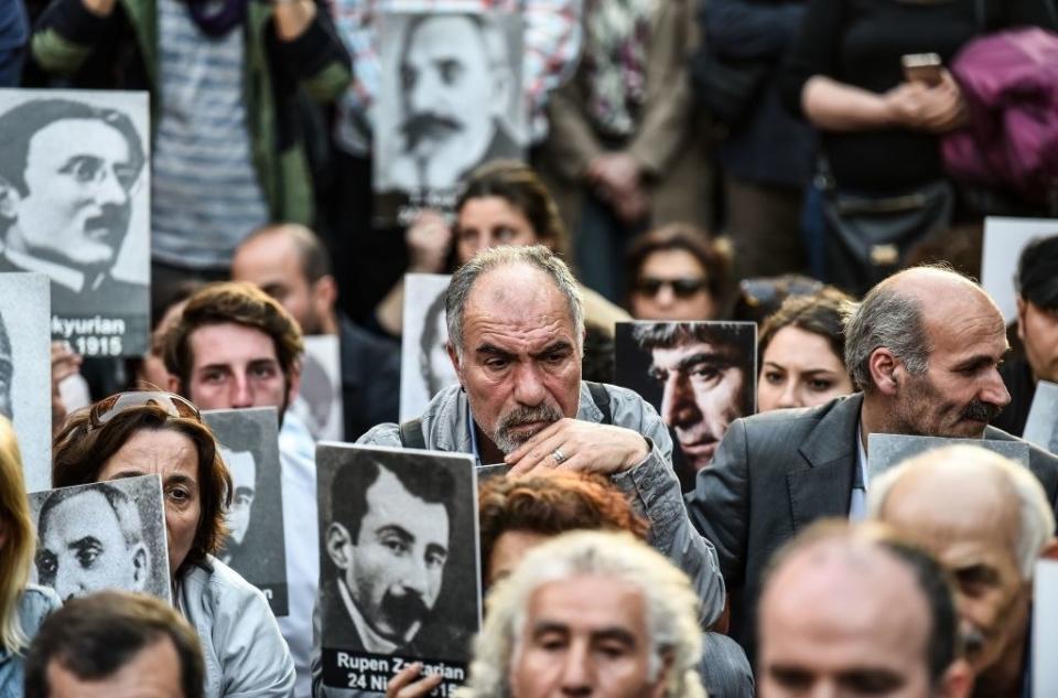 People hold up portraits of Armenian intellectuals at a rally in Istanbul to commemorate the Armenian massacre of 1915