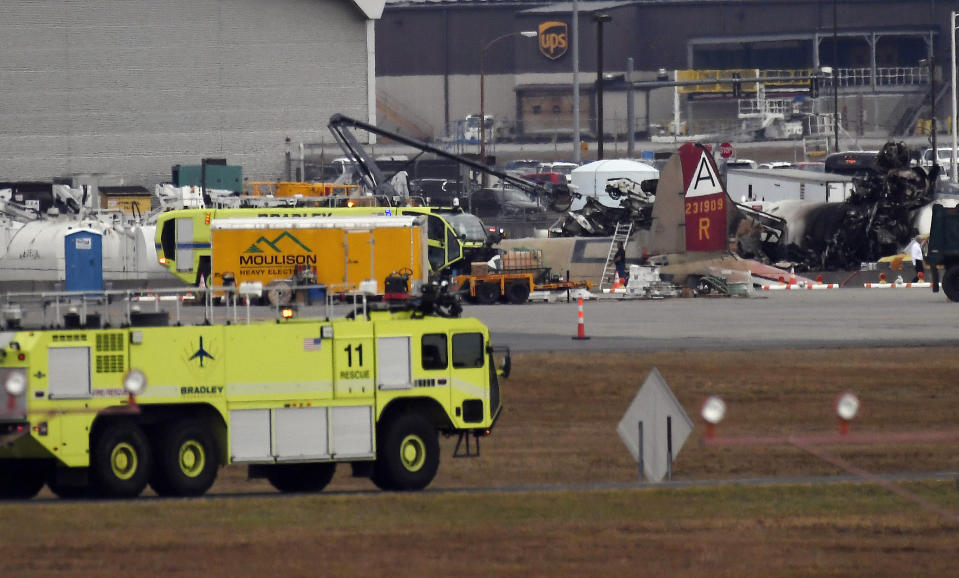 Emergency crews respond to where a World War II-era bomber B-17 plane crashed at Bradley International Airport in Windsor Locks, Conn., Wednesday, Oct. 2, 2019. (AP Photo/Jessica Hill)