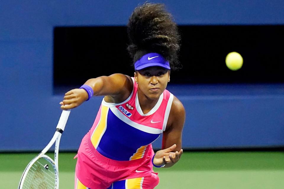 Naomi Osaka, of Japan, returns a shot to Anett Kontaveit, of Estonia, during the fourth round of the US Open tennis championships, in New York
