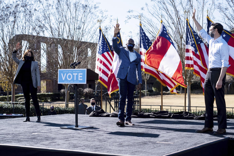 Vice President-Elect Kamala Harris, left, campaigns for Democratic U.S. Senate challengers the Rev. Raphael Warnock and Jon Ossoff, Monday, Dec. 21, 2020, in Columbus, Ga. (AP Photo/Ben Gray)