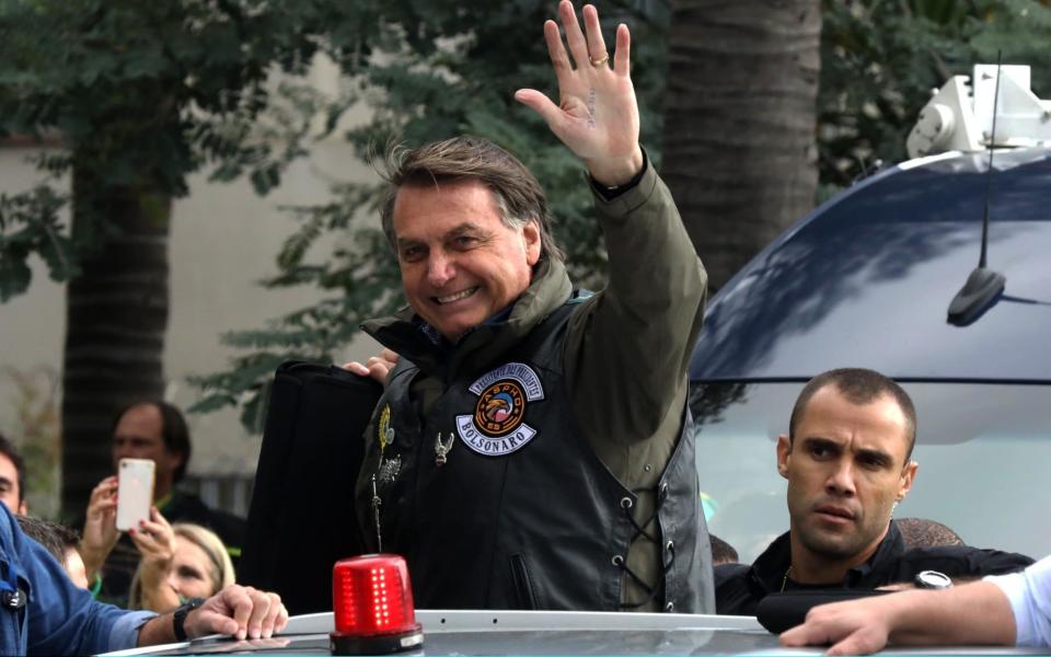 President of Brazil Jair Bolsonaro waves to supportes during a motorcycle rally through the streets of Sao Paulo on June 12, 2021 in Sao Paulo, Brazil. - Getty Images